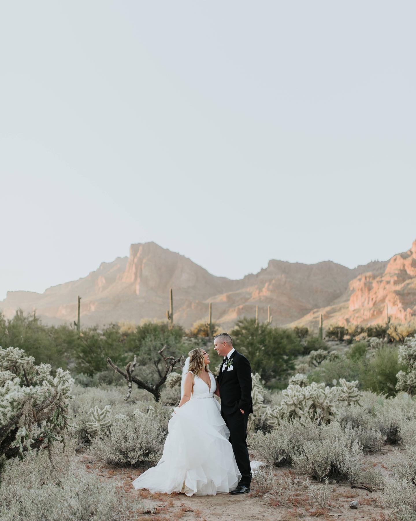Falling in love all over again in the desert…always an option! 
🤍🤍🤍
Photo: @christieknightphotography 
Video: @chayse.carmichael 
Venue: @clothandflameweddings 
Floral: @thewildflowersaz 
Cake: @abakeshop 
Live Painter: @liveeventartistaz 
Cigar Roller: @fumarcigars 
Custom Signage: @thedetailsduo 
Beauty: @hairmotty & @valeriafuertebeauty 
Couple: @alissamariealsup & @jason_alsup